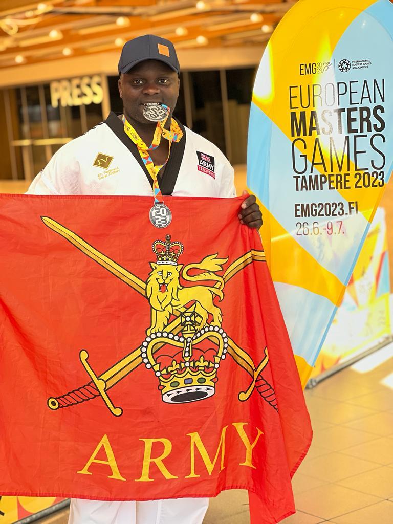 Yamie Guba at the European Masters Games with an Army flag