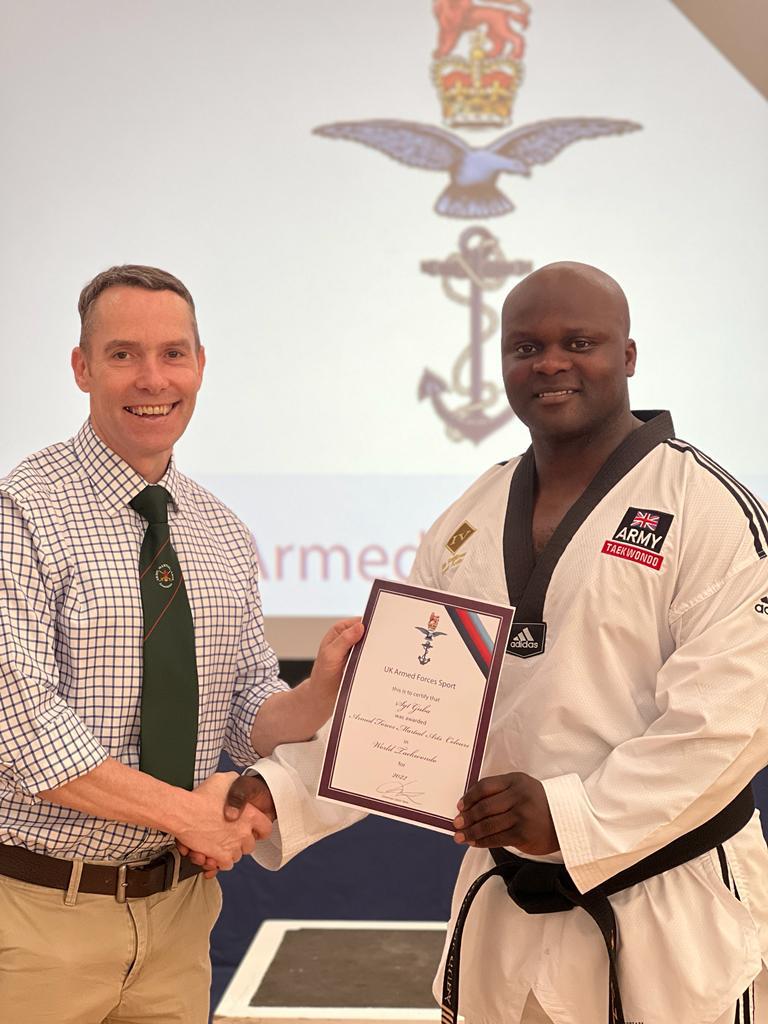 Yamie Guba receiving an award certificate